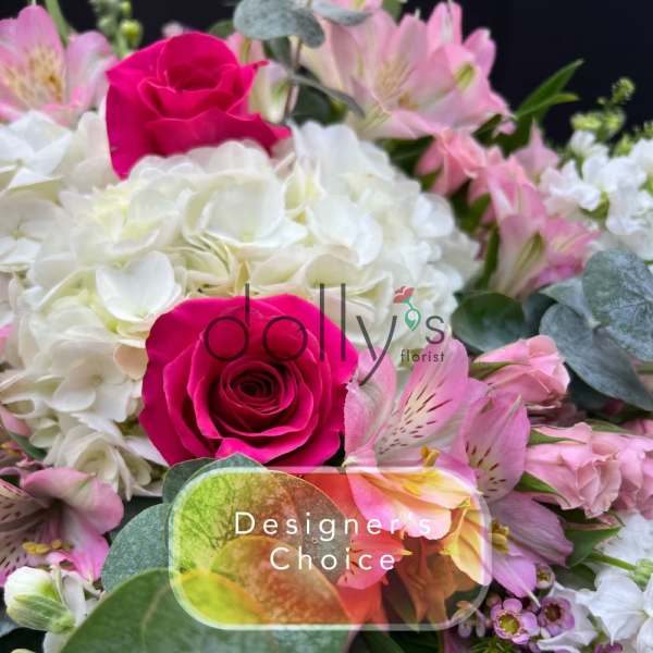 Bright arrangement with hot pink roses, white hydrangeas, and assorted pink flowers.