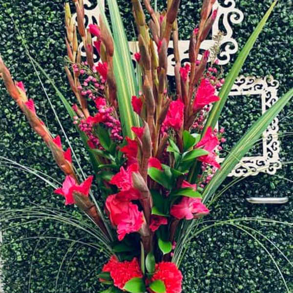 Tall pink floral arrangement in a clear glass vase