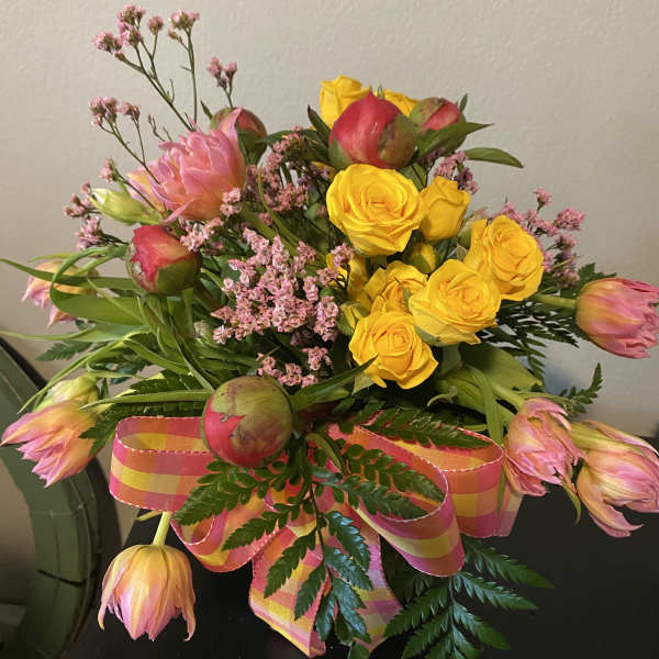 Peonies roses and tulips in a beautiful bubble bowl