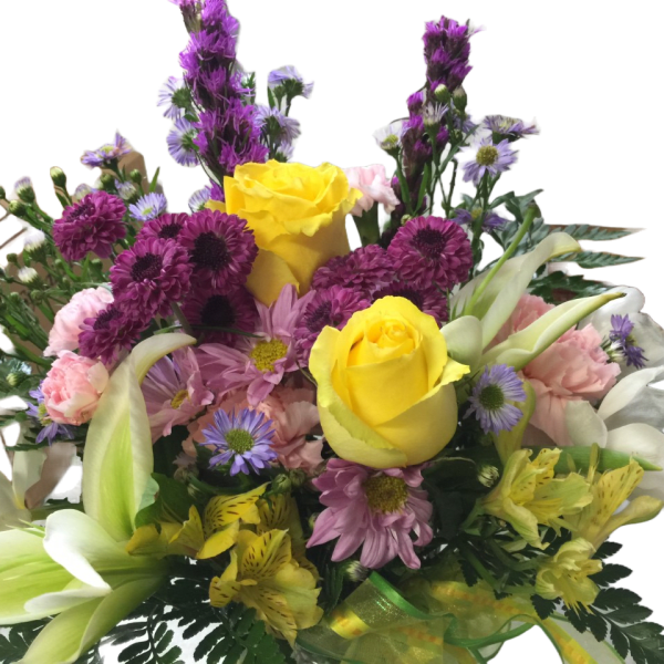 Bouquet of yellow roses, white calla lilies, and purple flowers