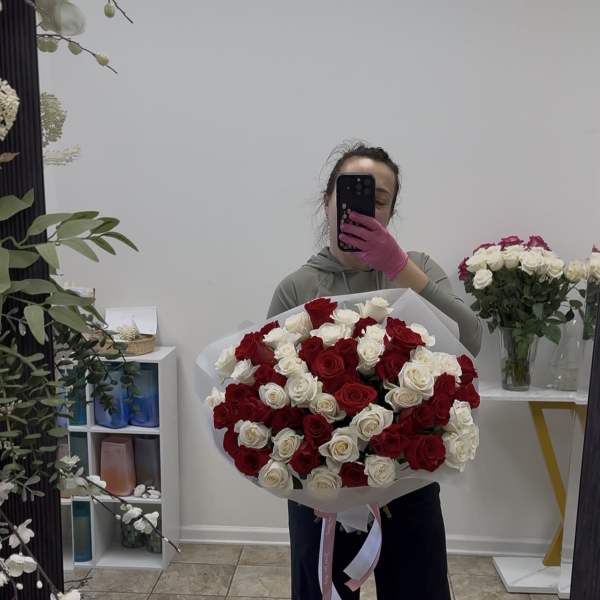 Large bouquet of red and white roses wrapped in white paper