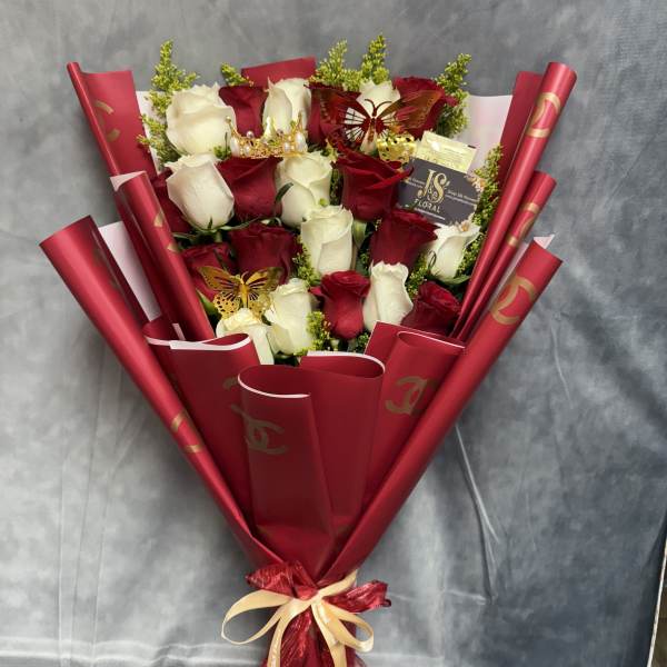 Bouquet of red and white roses wrapped in red paper