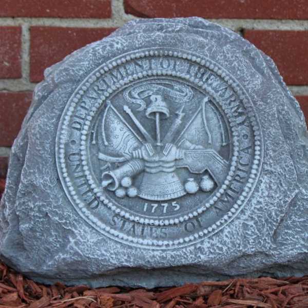 Engraved stone marker with a circular seal against a brick wall