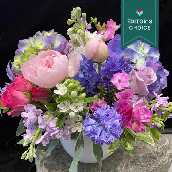 Pastel mixed flower arrangement in a white vase