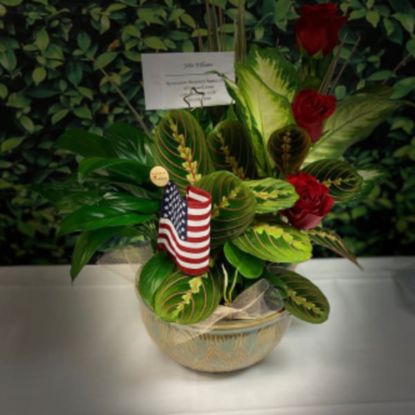 Potted arrangement with red roses and an American flag pick