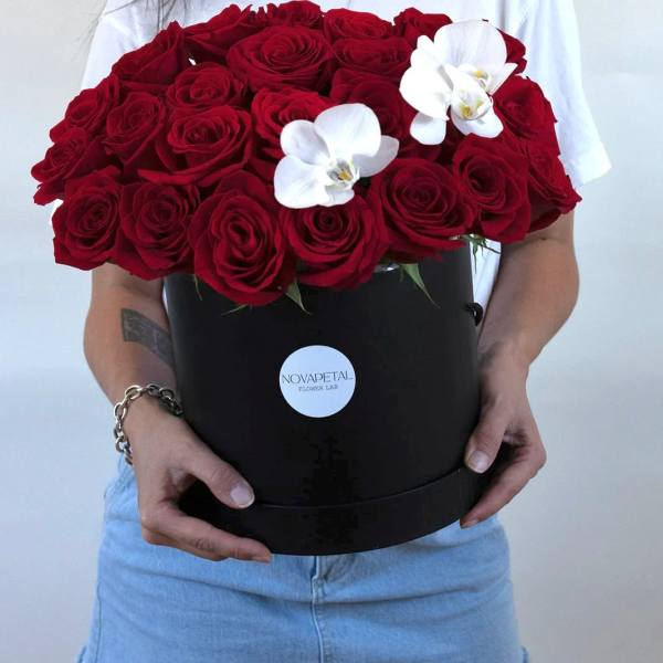 Large bouquet of red roses with two white orchids in a black box