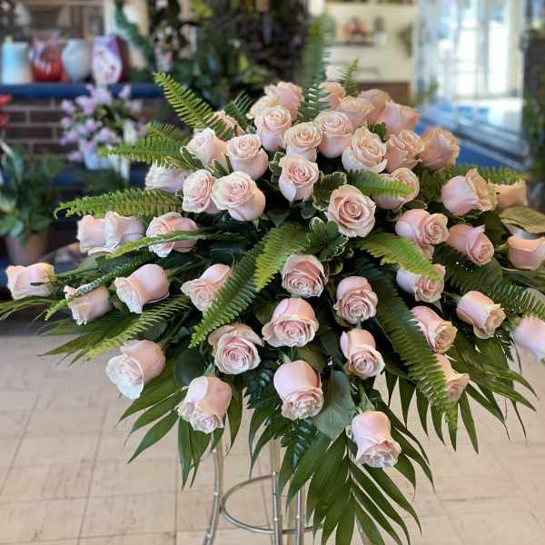 Large arrangement of pale pink roses with fern foliage