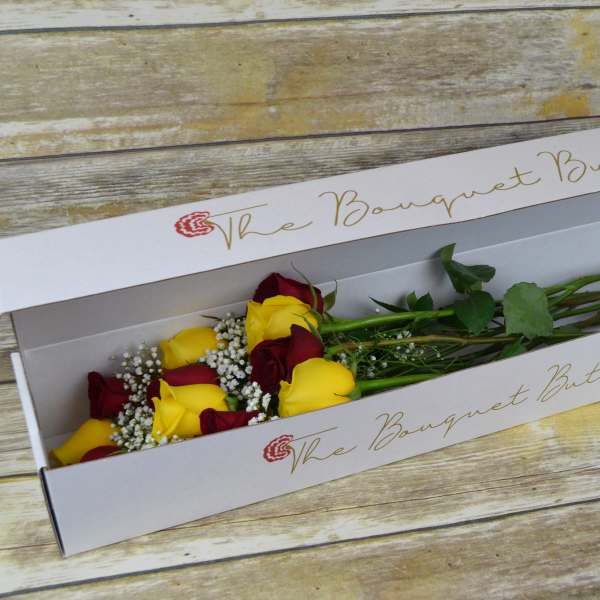 Boxed bouquet of red and yellow roses
