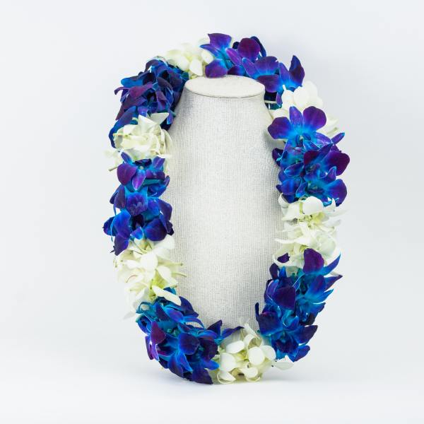 Blue and white orchid lei draped over a display bust