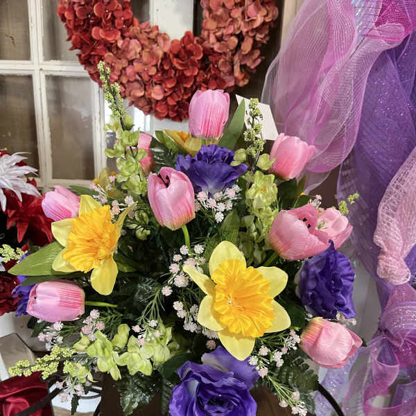 Colorful bouquet of tulips and daffodils in a glass vase