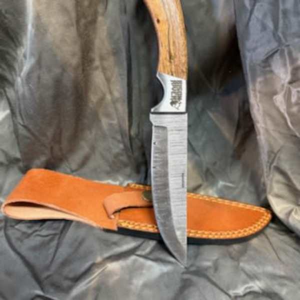 Fixed-blade knife with a wooden handle and leather sheath