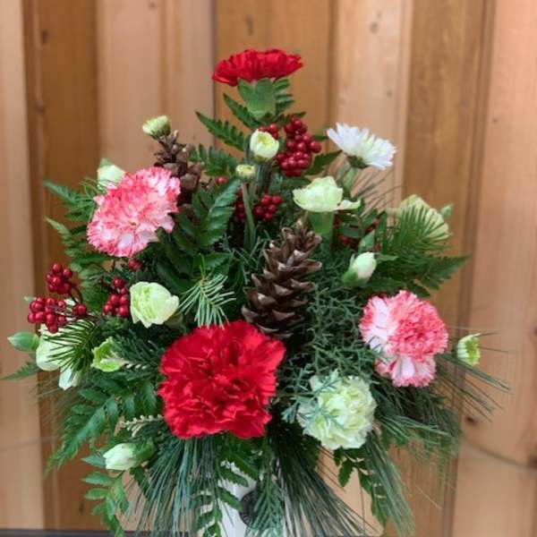 Mixed red, pink, and white flowers in a glass vase