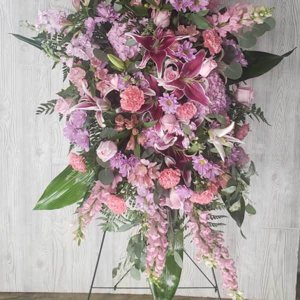 Tall pink and lavender floral standing spray on an easel