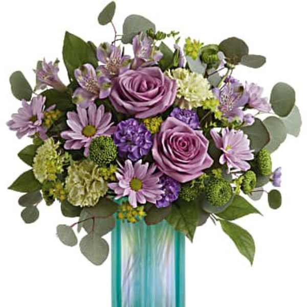 Lavender and purple bouquet in a turquoise glass vase