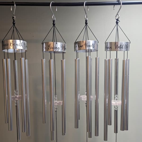 Four silver memorial wind chimes with hanging dove and heart ornaments