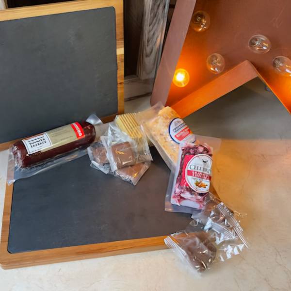 Assorted packaged chocolates and candies on wooden trays