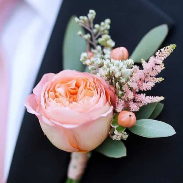 Peach rose boutonniere with pink filler and eucalyptus