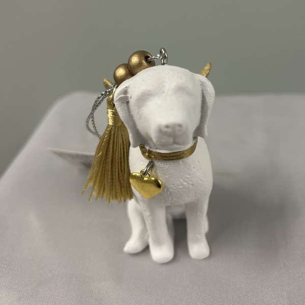 Small white dog figurine ornament with gold tassel and heart charm