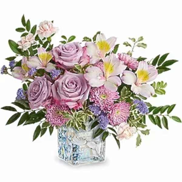 Lavender roses and pink flowers arranged in a square glass vase