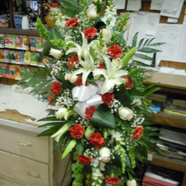 Tall floral spray with white lilies and red carnations