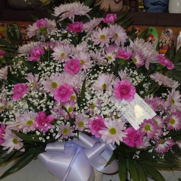 Large pink and white floral spray with a lavender ribbon