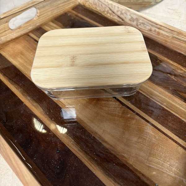 Wooden tray with a clear-lidded rectangular container on top