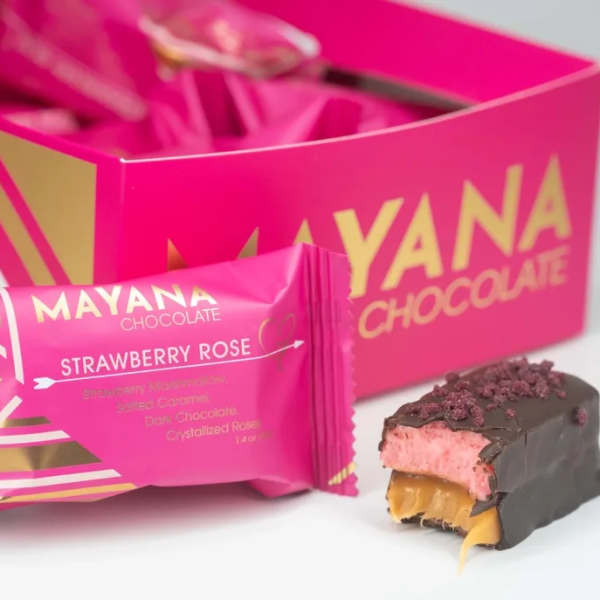 Pink chocolate gift box with a strawberry rose candy bar and a bitten chocolate piece