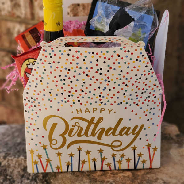 Birthday gift basket with wine, snacks, and a decorated box