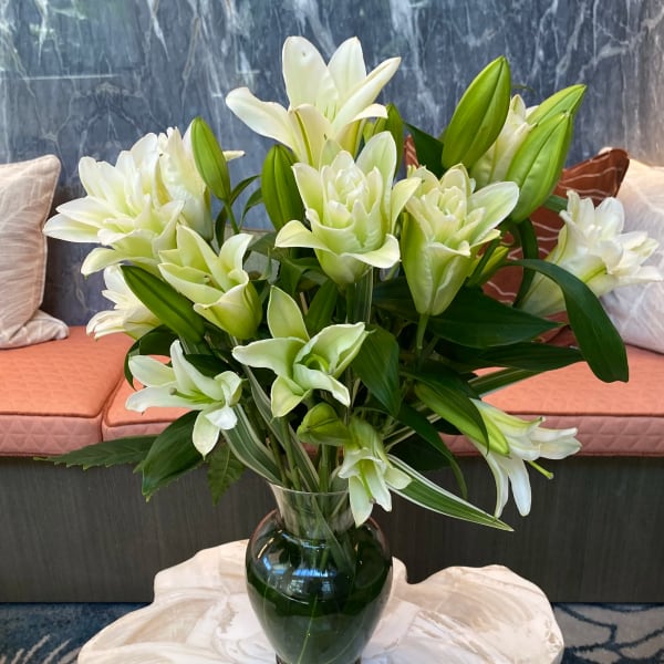 White lilies arranged in a glass vase