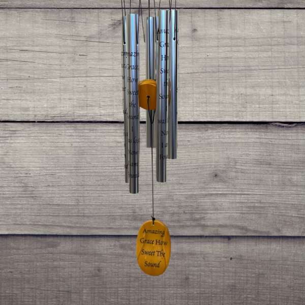 Hanging silver wind chime with a wooden top and yellow accent pieces