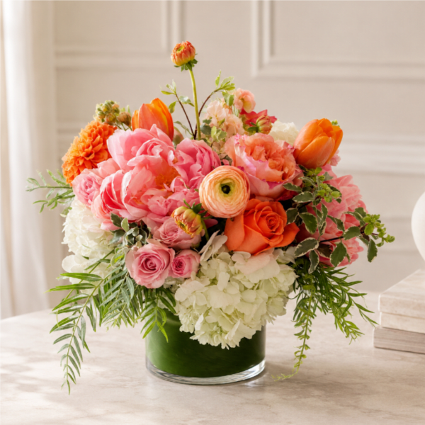 Pink and orange floral arrangement in a glass vase
