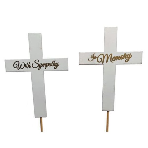 Two white memorial crosses with sympathy wording on stakes