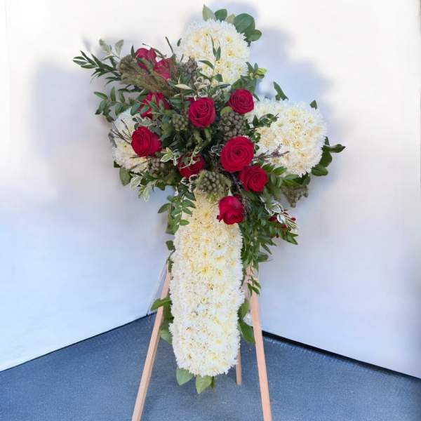 Standing floral spray with red roses and white chrysanthemums on an easel