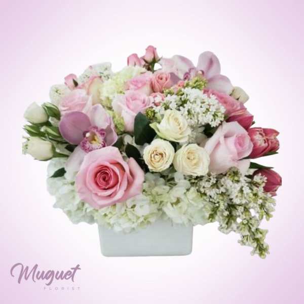 Pink and white rose bouquet in a white rectangular vase