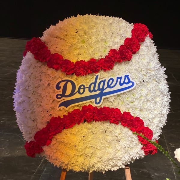 Large Dodgers floral display with white and red flowers on an easel