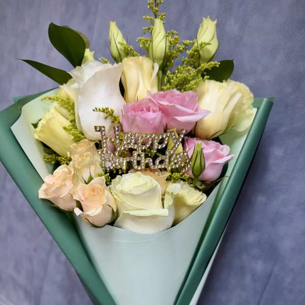 Bouquet of pink and white roses with a rhinestone "Happy Birthday" pick