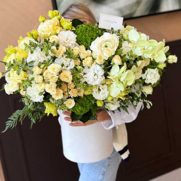 Large bouquet of white, cream, and pale green flowers