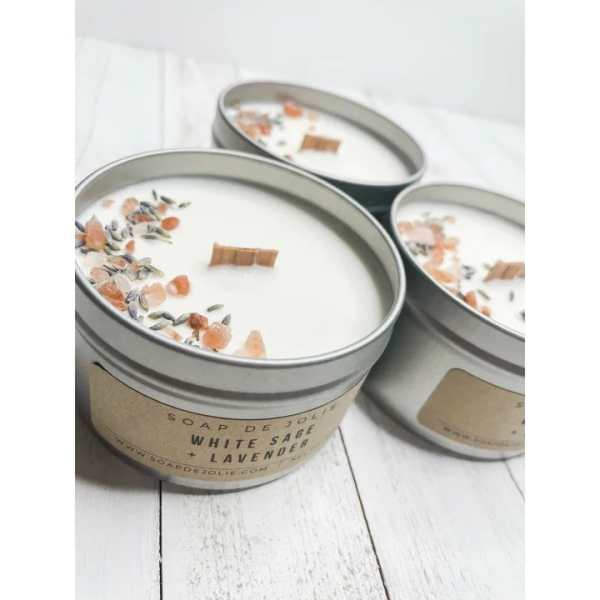 Three white sage and lavender tin candles with wood wicks and crystal and herb toppings