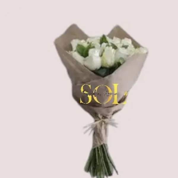 Bouquet of white roses wrapped in brown paper