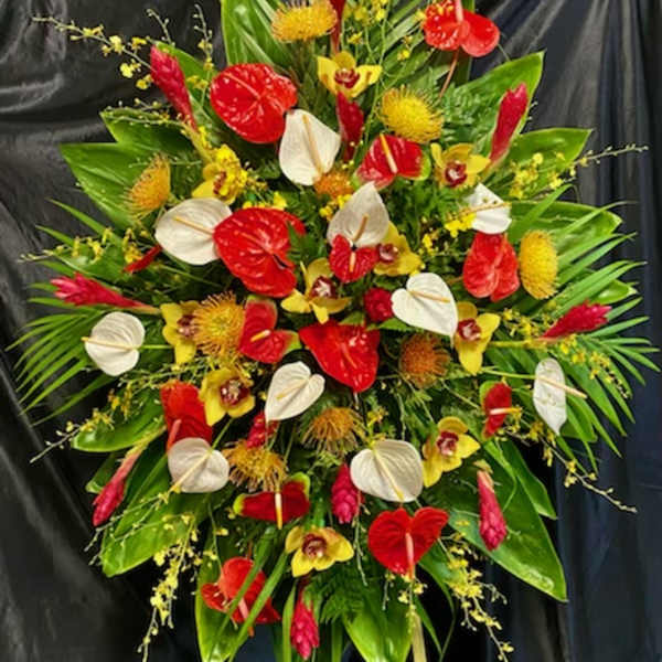 Large tropical floral spray with red and white anthuriums and yellow orchids