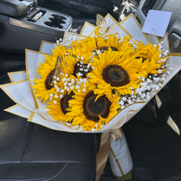 Bouquet of sunflowers with white baby's breath in white and gold wrap