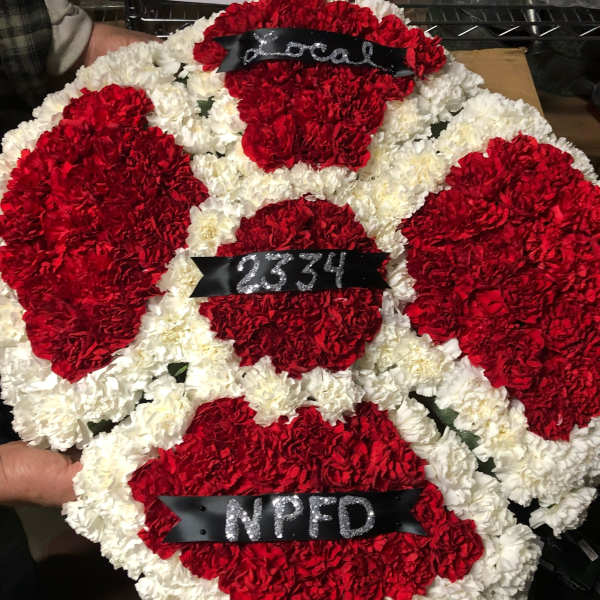 Red and white carnation wreath with black ribbons and silver lettering