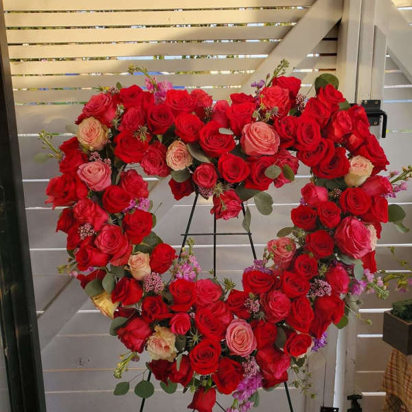 Heartfelt sympathy floral in red and pink roses by Barrio Logan florist