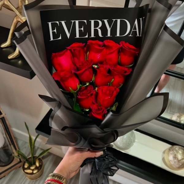 Bouquet of red roses wrapped in black and gray paper