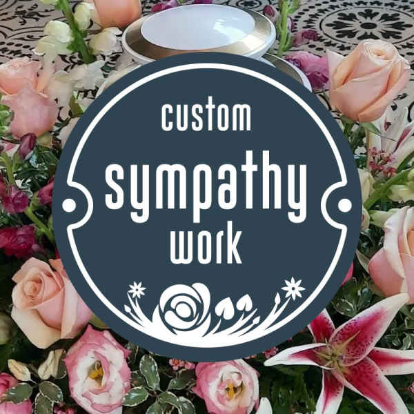 Sympathy floral arrangement with pink roses and lilies