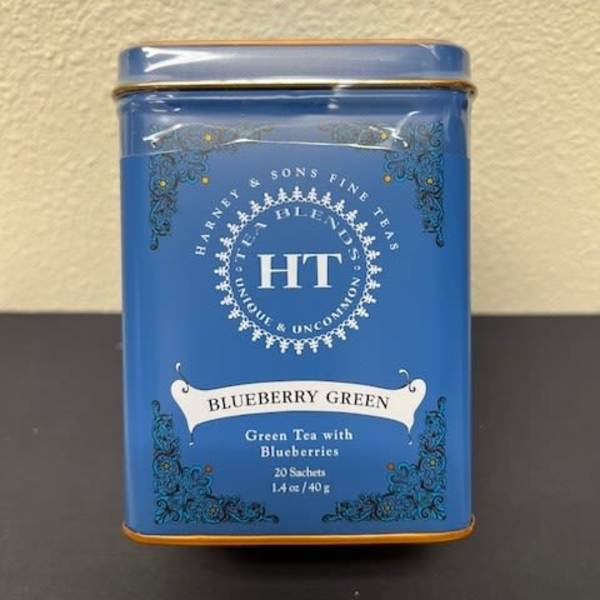 Blue tin of blueberry green tea on a table