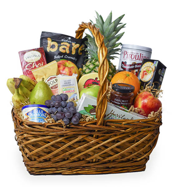 Gift basket with fruit, snacks, and a pineapple centerpiece