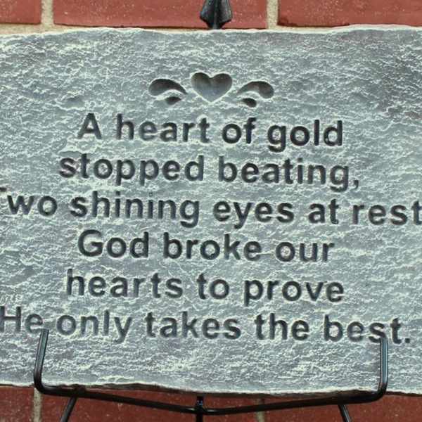Engraved memorial stone with a poem on a metal stand