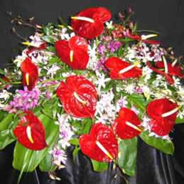 Bouquet of red anthuriums with small white and purple flowers