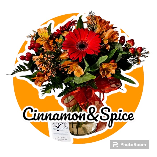 Bouquet with a red gerbera daisy and orange flowers in a glass vase